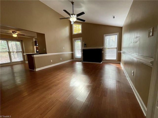 unfurnished living room with hardwood / wood-style floors, a wealth of natural light, and ceiling fan