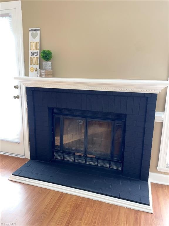 room details featuring hardwood / wood-style floors and a fireplace