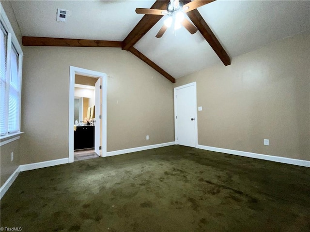 interior space with lofted ceiling with beams, dark colored carpet, and ceiling fan