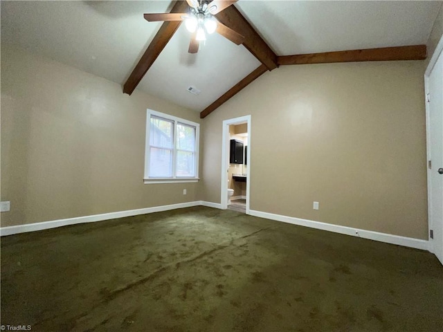 interior space featuring dark colored carpet, vaulted ceiling with beams, and ceiling fan