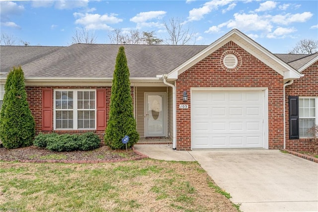 ranch-style house featuring an attached garage, brick siding, concrete driveway, and roof with shingles