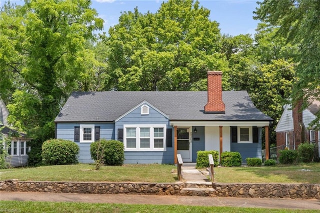 2505 Druid Hills Dr, Winston-Salem, NC 27105 - bungalow-style house with a chimney, covered porch, a front yard, and roof with shingles