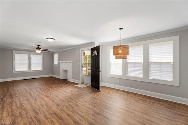 2505 Druid Hills Dr, Winston-Salem, NC 27105 - unfurnished living room featuring crown molding, dark wood-type flooring, a brick fireplace, ceiling fan, and a chandelier