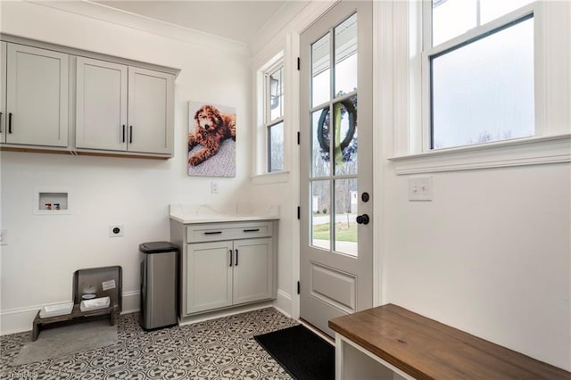 interior space with light tile patterned floors, baseboards, and crown molding