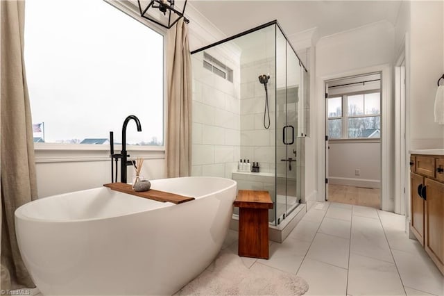 full bath featuring a soaking tub, a stall shower, and ornamental molding