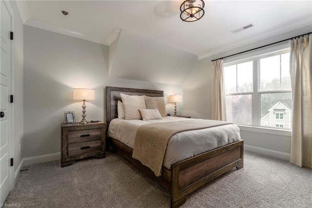 carpeted bedroom with visible vents, baseboards, and crown molding