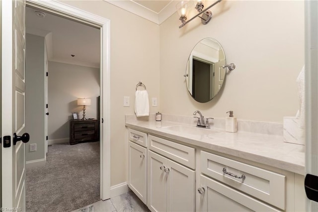 bathroom with baseboards, vanity, and crown molding