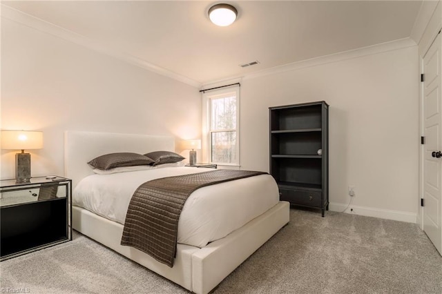 carpeted bedroom with baseboards, visible vents, and ornamental molding