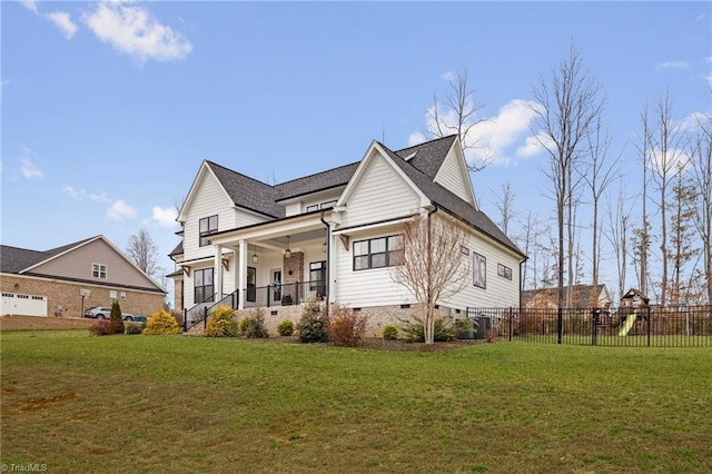 view of front of home featuring a porch, a playground, a front lawn, and fence