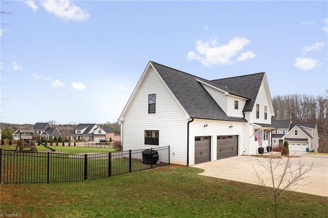 view of property exterior featuring fence, roof with shingles, an attached garage, concrete driveway, and a lawn