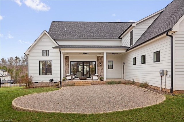 rear view of property featuring a patio, a ceiling fan, and a shingled roof