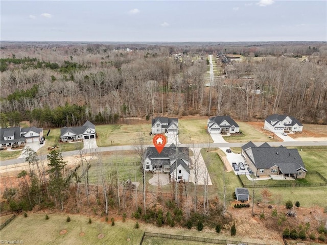 drone / aerial view with a wooded view