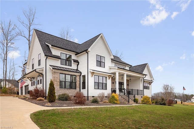 modern farmhouse featuring a front yard, driveway, covered porch, crawl space, and brick siding