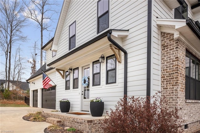 view of property exterior with brick siding, crawl space, concrete driveway, and a garage