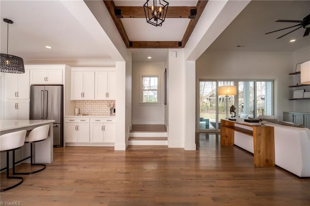 kitchen with wood finished floors, open floor plan, a wealth of natural light, and high end refrigerator