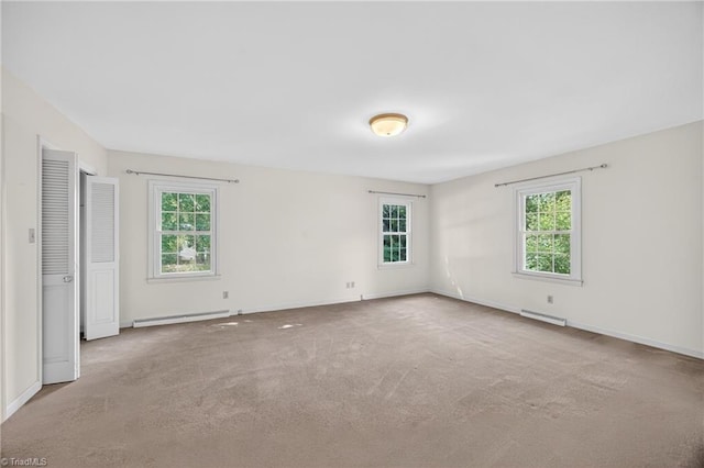 1409 Coventry Rd, High Point, NC 27262 - carpeted spare room featuring a baseboard heating unit and healthy amount of natural light
