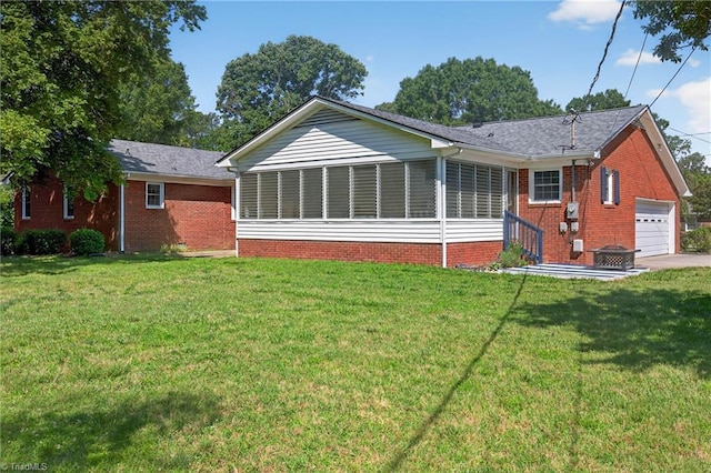 1409 Coventry Rd, High Point, NC 27262 - rear view of house featuring brick siding, a yard, a sunroom, and a garage