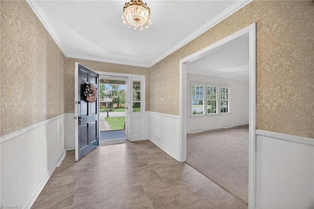 1409 Coventry Rd, High Point, NC 27262 - entrance foyer with wallpapered walls, ornamental molding, wainscoting, and a chandelier