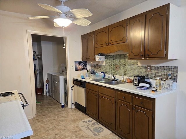 2205 Sunderland Rd Unit 107D, Winston-Salem, NC 27103 - kitchen with washing machine and dryer, a sink, white appliances, light countertops, and tasteful backsplash