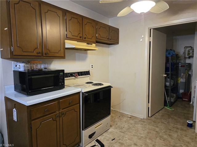 2205 Sunderland Rd Unit 107D, Winston-Salem, NC 27103 - kitchen with electric stove, under cabinet range hood, black microwave, water heater, and light countertops