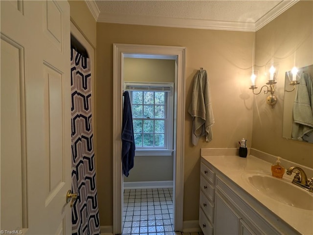 bathroom featuring vanity, ornamental molding, a textured ceiling, and tile patterned flooring