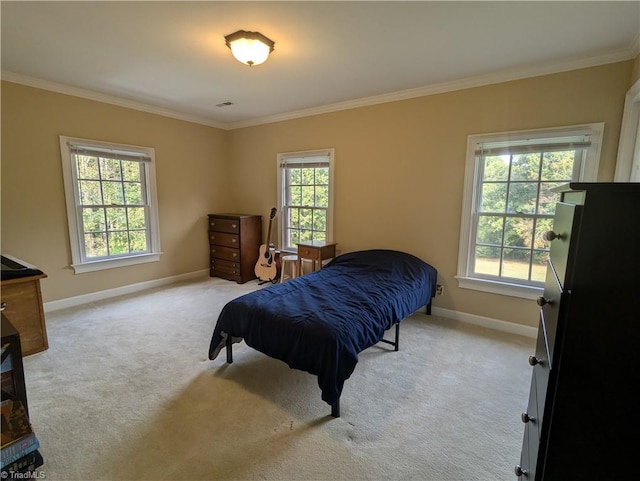 bedroom featuring light carpet and multiple windows