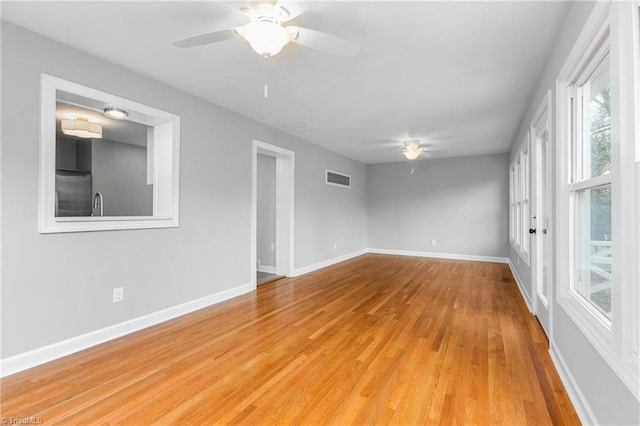 spare room featuring light hardwood / wood-style floors, ceiling fan, and sink