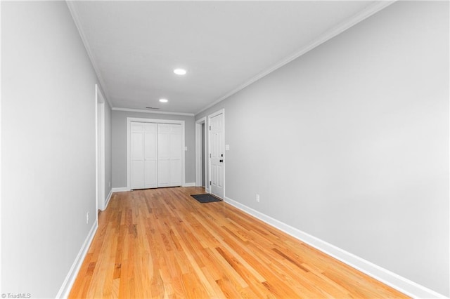 hall featuring crown molding and light hardwood / wood-style flooring