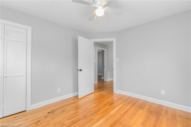 unfurnished bedroom with a closet, ceiling fan, and light hardwood / wood-style flooring