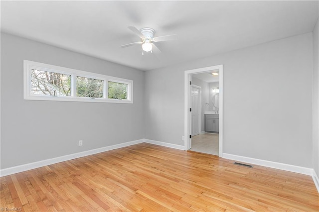 unfurnished bedroom with connected bathroom, ceiling fan, and light wood-type flooring