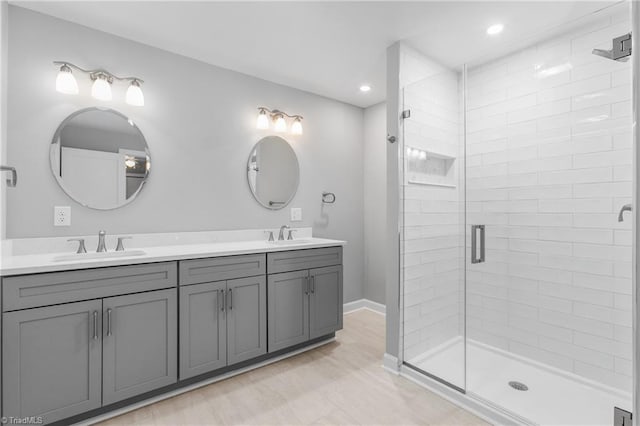 bathroom with vanity and a shower with door