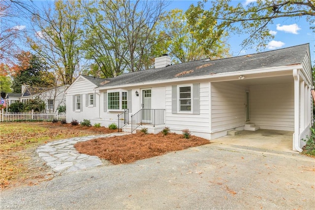 ranch-style house featuring a carport