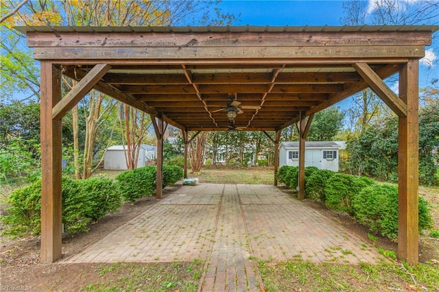 view of patio featuring ceiling fan and a storage unit