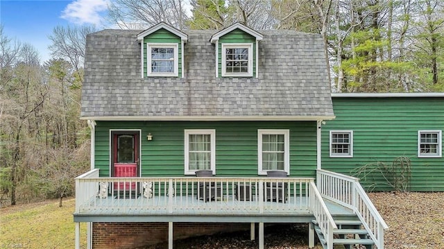 back of house featuring a wooden deck and a shingled roof