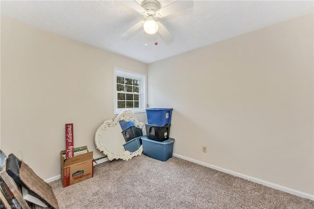 rec room with baseboards, carpet, ceiling fan, and a textured ceiling