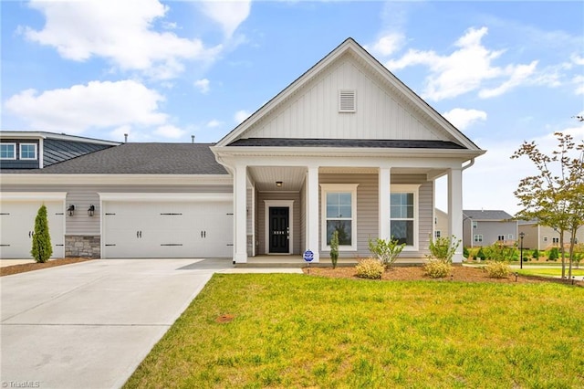 view of front facade featuring a front lawn, a porch, and a garage