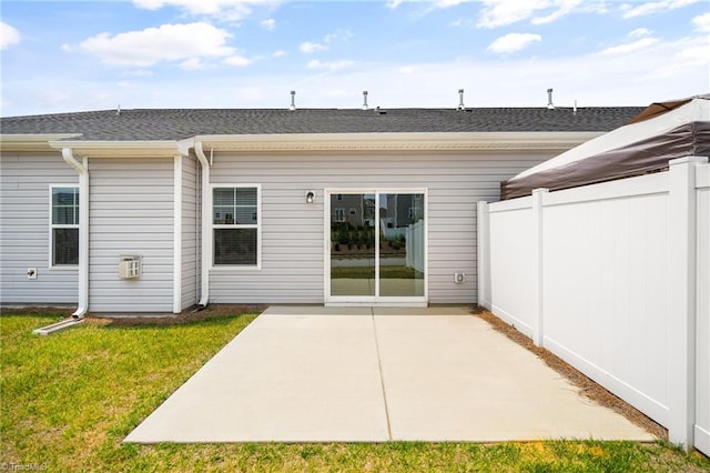 back of house featuring a yard and a patio