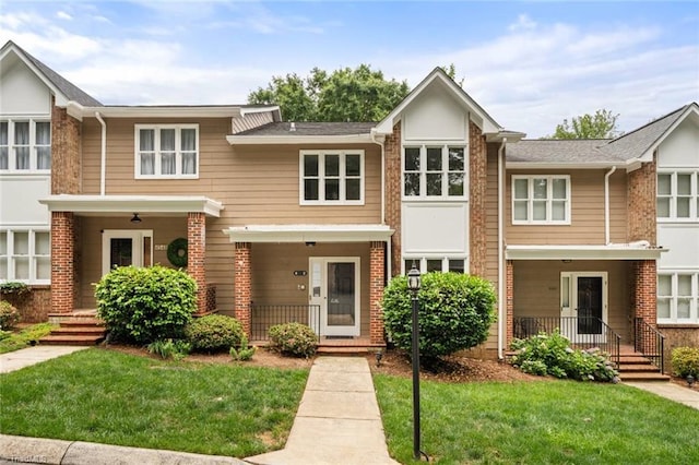 4552 Fernhaven Cir, Winston-Salem, NC 27104 - townhome / multi-family property with covered porch, brick siding, and a front yard