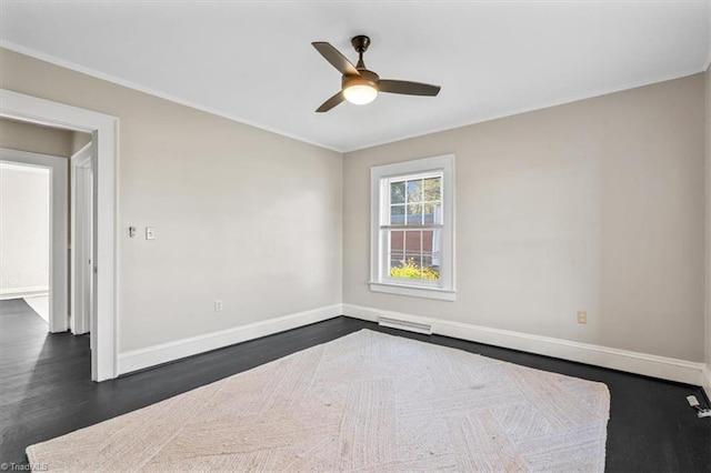 spare room featuring ceiling fan and dark hardwood / wood-style floors