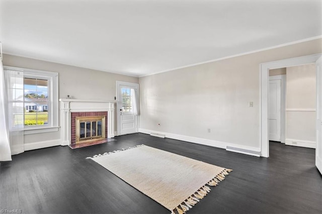 unfurnished living room featuring ornamental molding, dark wood-type flooring, and a brick fireplace