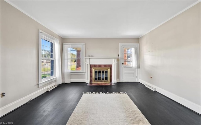 unfurnished living room with a fireplace, ornamental molding, and dark hardwood / wood-style floors