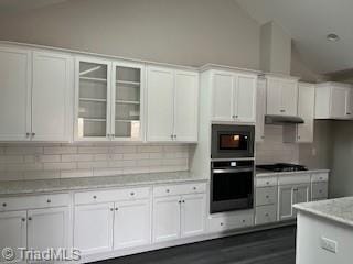 kitchen with white cabinetry, dark hardwood / wood-style flooring, double oven, decorative backsplash, and high vaulted ceiling