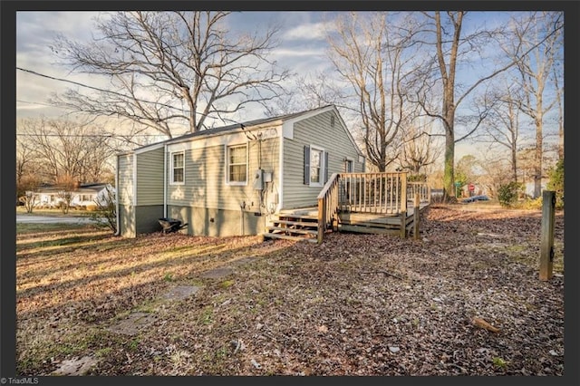 view of side of home featuring crawl space and a deck