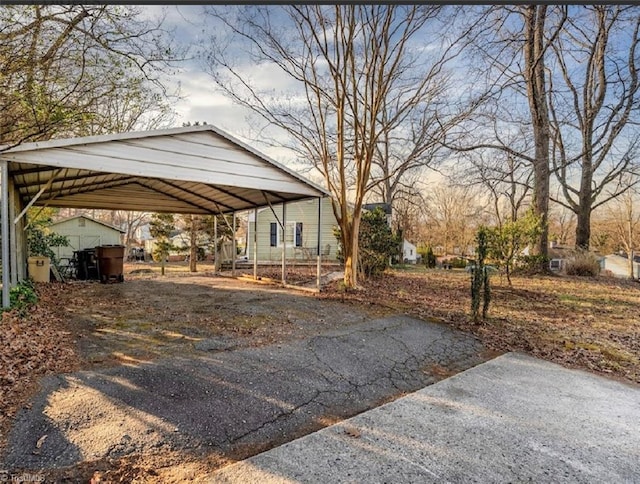 view of front of home featuring a carport and aphalt driveway