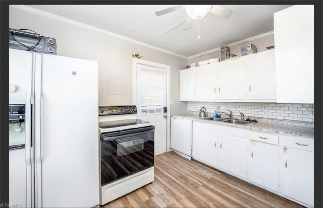 kitchen featuring white appliances, ornamental molding, a sink, light countertops, and white cabinetry