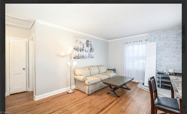 living room featuring crown molding, light wood-style flooring, and baseboards