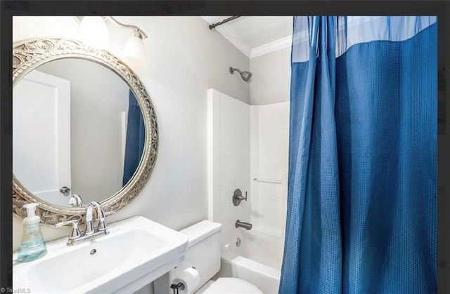 bathroom with crown molding, toilet, shower / bath combo, and a sink