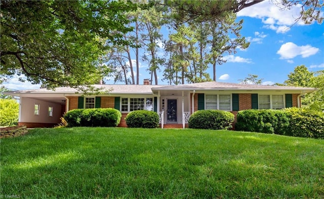 2005 Faculty Dr, Winston-Salem, NC 27106 - single story home with brick siding, a carport, a front lawn, and a chimney