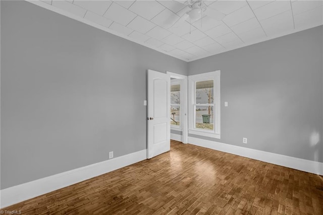 empty room with hardwood / wood-style flooring and ceiling fan