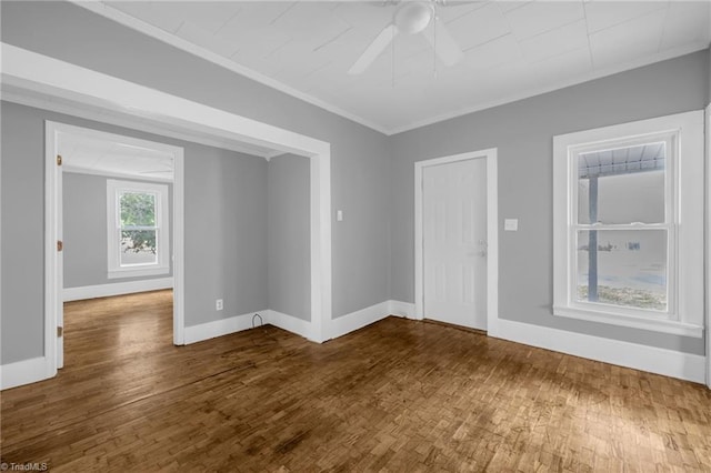 spare room with ceiling fan, ornamental molding, and wood-type flooring